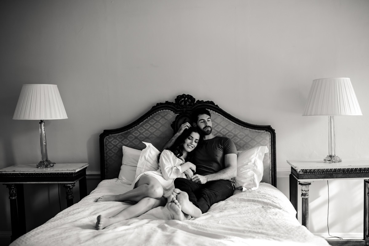 the-wedding-couple-is-resting-on-the-bed-and-being-photographed-by-photographer-at-came-house-wedding